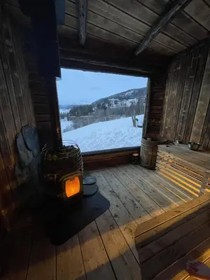 an inside view of a room with a view of a snow covered field at The blue room at Vevstogo - cosy with a mesmerizing view, sauna and eco living in an old school house in Løken