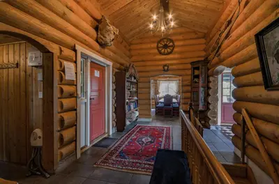 a hallway in a log cabin with a red door at Large Cabin With Stunning Views! in Beitostøl