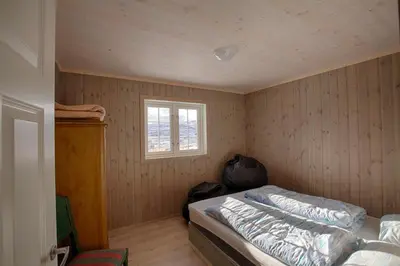 a small bedroom with a bed and a window at Modern Cabin At The Foot Of Bitihorn in Beitostøl