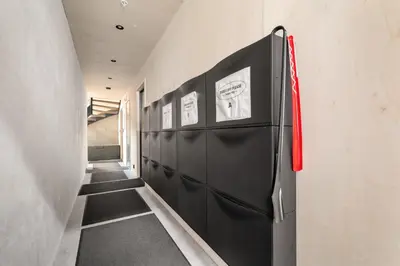 a hallway with a black refrigerator in a room at Comfy studio apartment 200m from bryggen in Bergen