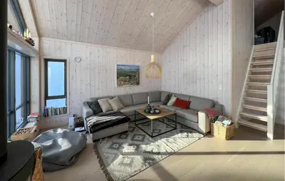 a living room with a couch and a table at Gorgeous Home In Kvam With Sauna in Kvam