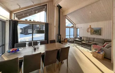 a dining room with a table and a couch at Gorgeous Home In Kvam With Sauna in Kvam