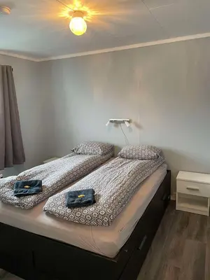 two twin beds in a room with a light on the ceiling at Leilighet i Sør-Fron kommune in Sør-Fron