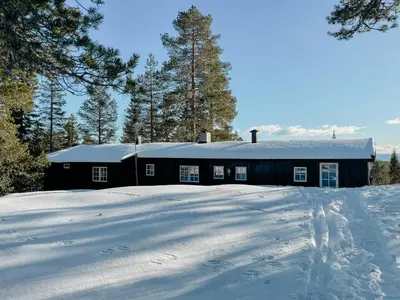 a black building with snow in front of it at Modernized Cabin At Norefjell With View in Eggedal