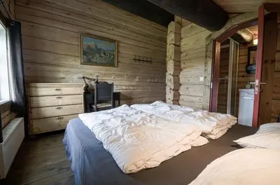 a bedroom with a large bed and a desk at Charming Timber Lodge For Gathering And Celebrations in Beitostøl