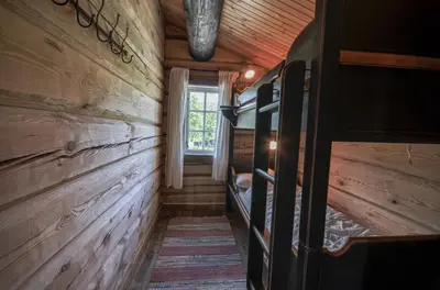 a hallway in a log cabin with a window at Charming Timber Lodge For Gathering And Celebrations in Beitostøl
