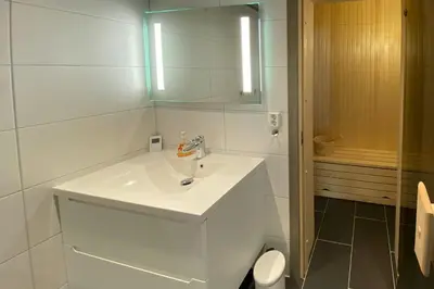 a white bathroom with a sink and a mirror at Modern Apartment With Views Of Trysil Mountain in Trysil