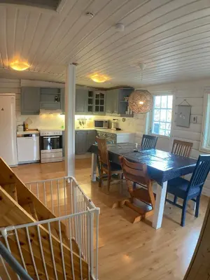 a kitchen and dining room with a table and chairs at Child-friendly holiday home in Ålesund