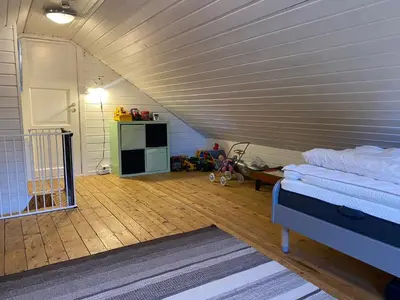 a room with a attic with a bed and a kitchen at Child-friendly holiday home in Ålesund