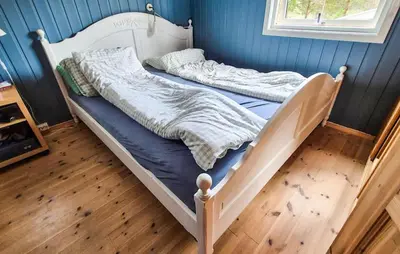 a bedroom with two beds in a blue wall at 2 Bedroom Amazing Home In Agdenes in Fremstad