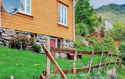 a wooden fence in front of a house at 3 Bedroom Lovely Home In Valen in Valen