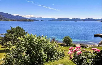 a view of a large body of water with pink flowers at 3 Bedroom Lovely Home In Valen in Valen