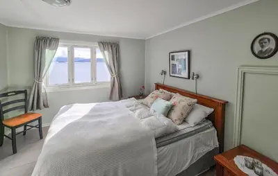 a bedroom with a white bed with a window at 3 Bedroom Lovely Home In Valen in Valen