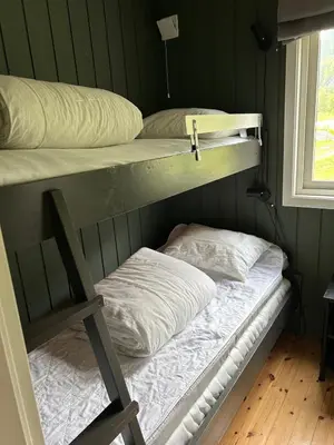 two bunk beds in a room with a window at Cabin in Valldalen, Røldal in Røldal