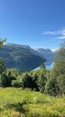 a view of a body of water from a hill at Cabin in Valldalen, Røldal in Røldal