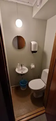 a bathroom with a toilet and a sink at Haugen Gård in Oppdal