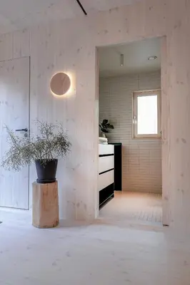 a room with a potted plant sitting on a stump at The Crux Nordic Design Mountain Cabin in Åndalsnes