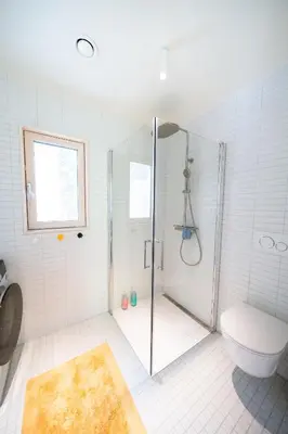 a bathroom with a shower and a toilet at The Crux Nordic Design Mountain Cabin in Åndalsnes