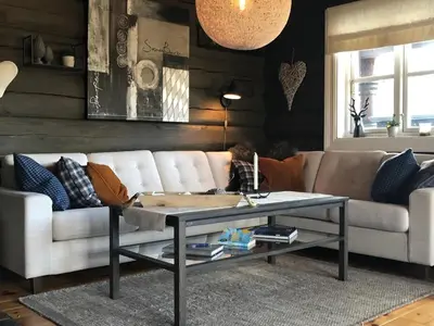 a living room with a couch and a coffee table at Siribu in Vågsli