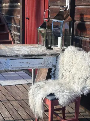 a white table with a bench with a white faux furussion at Nord-Garthus gård leilighet 1 in Hølera