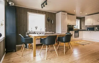 a kitchen with a wooden table and chairs at Family Cabin With Ski Inout In Rauland in Rauland