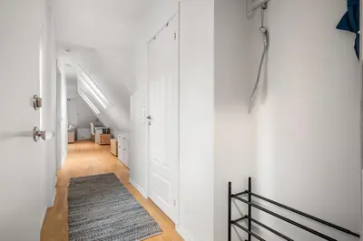a hallway with a white door and a rug at Scandinavian Hideaway I Private Balcony in Bergen