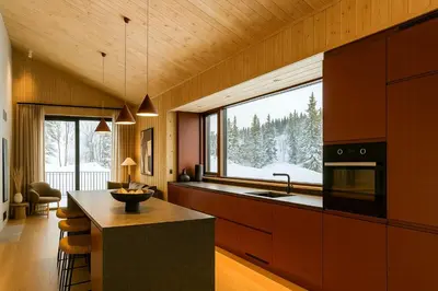a kitchen with a counter and a large window at Architect Designed Mountain Cabin At Kvitfjell in Favang
