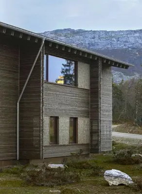 a house with a large window on the side of it at Architect Designed Mountain Cabin At Kvitfjell in Favang