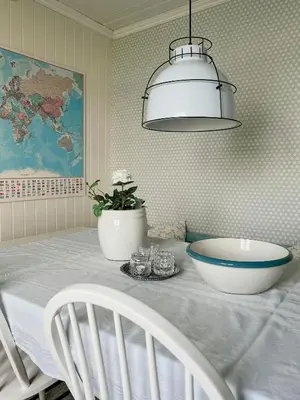 a dining room table with a blue and white bowl on it at Peaceful Log Cabin By The Fjord On Ytterøy in Ytteroy