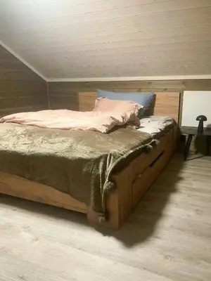 a bed with a wooden frame in a room at Mountain Cabin With Panoramic Views In Savalen in Tynset