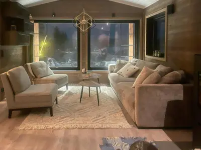 a living room with a couch and two chairs at Mountain Cabin With Panoramic Views In Savalen in Tynset