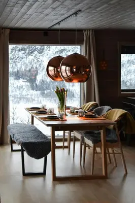 a dining room table with chairs and a large window at Mountain Cabin By The Ski Trails In Rauland in Rauland