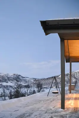 a porch with a swing in the snow at Mountain Cabin By The Ski Trails In Rauland in Rauland