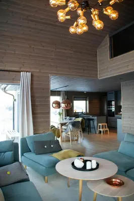 a living room with blue couches and a table at Mountain Cabin By The Ski Trails In Rauland in Rauland
