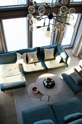 a living room with a blue couch and a table at Mountain Cabin By The Ski Trails In Rauland in Rauland
