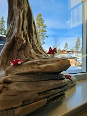 a pile of books sitting on a window sill at Modern Cabin With Panoramic Views Near Langedrag in Tunhovd
