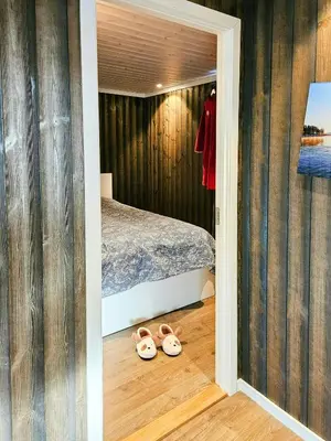 a bedroom with a bed and two pairs of slippers at Modern Cabin With Panoramic Views Near Langedrag in Tunhovd