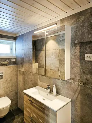 a bathroom with a sink and a toilet at Modern Cabin With Panoramic Views Near Langedrag in Tunhovd