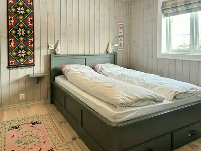 a bed sitting in a room with a window at Family Cabin With Ski In Ski Out in Trysil