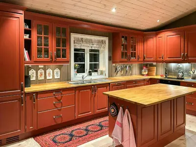 a large kitchen with red cabinets and a sink at Family Cabin With Ski In Ski Out in Trysil