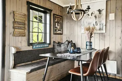 a dining room with a table and chairs at Cosy Cabin With Annex At Blefjell in Kongsberg