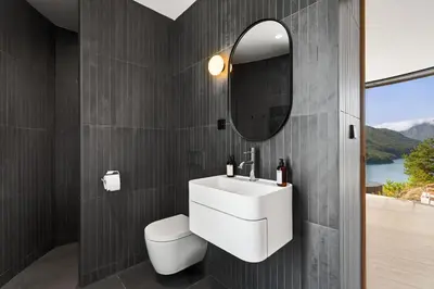 a bathroom with a white sink and a mirror at The Sognefjord Cabin in Kaupanger