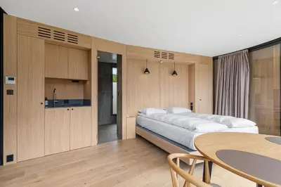 a bedroom with a large bed and a table at The Sognefjord Cabin 2 in Kaupanger