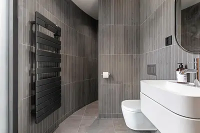 a bathroom with a sink and a toilet and a mirror at The Sognefjord Cabin 2 in Kaupanger