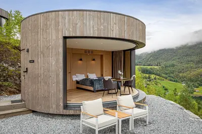 a circular house on a hill with a bedroom at The Sognefjord Cabin 2 in Kaupanger