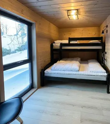 a bedroom with two bunk beds and a window at Fjord Cabin With Panoramic Views In Rauma in Innfjorden