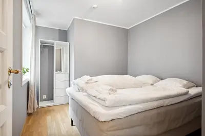 a bedroom with a large white bed with white pillows at Apt 500 m to Bryggen - Perfect location in Bergen