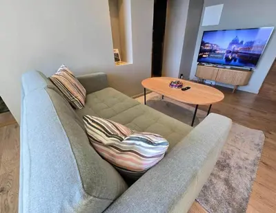 a living room with a couch and a table at Oceanview Apartment Aalesund in Ålesund
