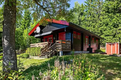 a small wooden cabin with a red roof at Cottage w Wilderness Feeling 20 min from airport in Maura
