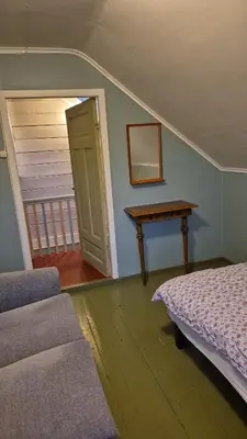 a bedroom with a table and a bed and a table at Nygjerdet Gossen in Gossa